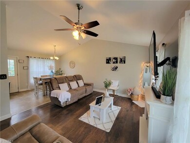 Living Room/ Dining Room (open concept with cathedral ceilings)