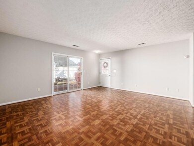 LIVING ROOM WITH ENTRY TO PRIVATE PATIO