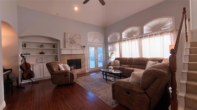Living room featuring ceiling fan, built in featur