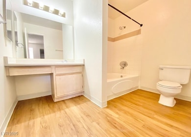 Bathroom with wood finished floors, vanity, and sh