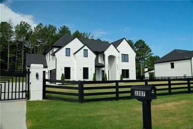 View of front facade with a fenced front yard, a gate, and a shingled roof