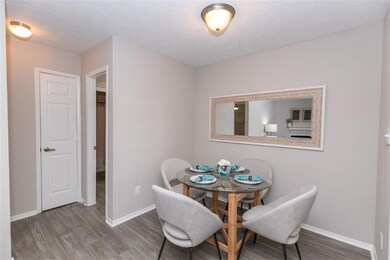 Dining area with hardwood / wood-style flooring and a textured ceiling