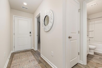 Doorway to outside featuring baseboards and wood finished floors