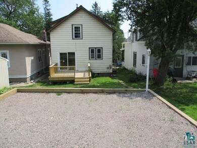Back of property with a lawn