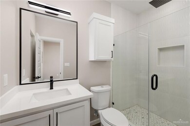 Bathroom featuring a shower stall and vanity