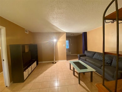 Family room with entertainment center, TV, table,