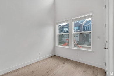Additional living space featuring healthy amount of natural light and light wood-style floors