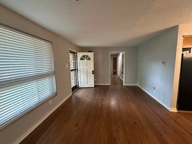 Entryway featuring a textured ceiling, baseboards,