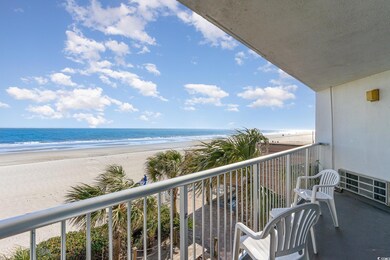 Balcony with a water view and a view of the beach