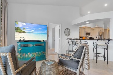 Tiled living room featuring high vaulted ceiling