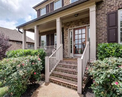 The walkway leads you to a covered front porch - perfect for that morning cup of cofee.