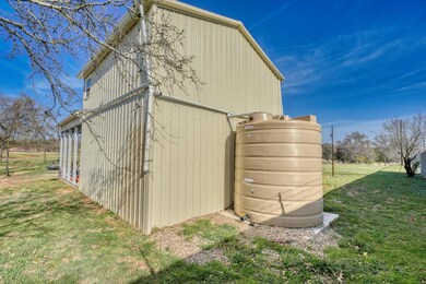 View of pole building featuring a yard