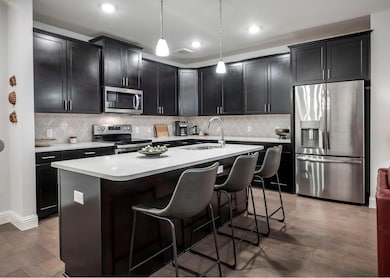Kitchen featuring an island with sink, hardwood / 