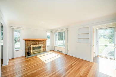 Living Room with Built in Features, a Fireplace, and Hardwood Floors