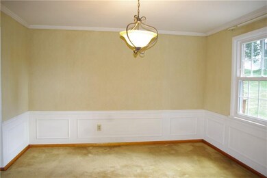 Formal dining area features wainscoting, crown mol