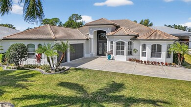 Hangar home with stucco siding, a tile roof, a garage, and a front yard