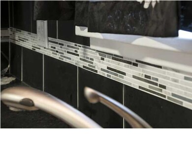 Updated kitchen with glass tile backsplash