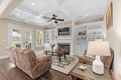 Living room with ceiling fan, dark wood-type floor