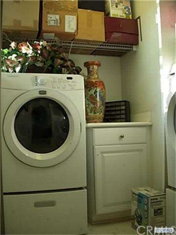Laundry Room at first floor with cabinets and hang