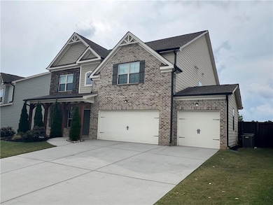Craftsman house with concrete driveway, a garage, brick siding, and roof with shingles