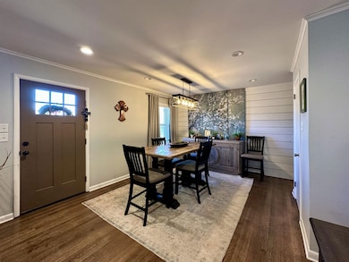 Dining space with dark hardwood / wood-style floor