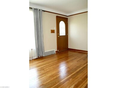 Gleaming hardwood floors, cove ceiling and crown molding in the living room