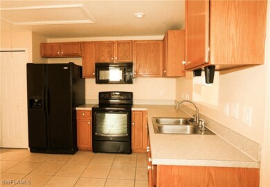 Kitchen featuring light tile patterned floors, bro