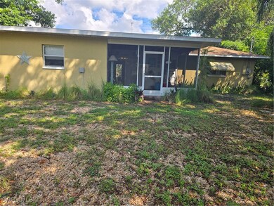 Rear view of property with a sunroom