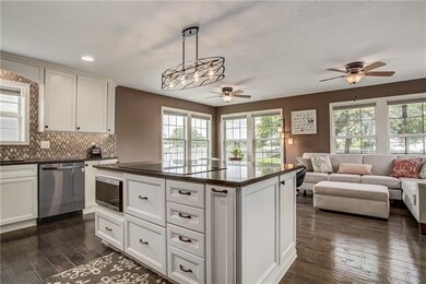 Incredibly open kitchen facing a wall of windows a