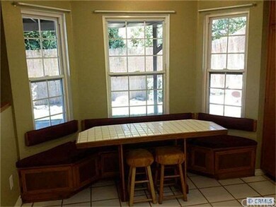 Cheery breakfast nook has built-in bay window benc