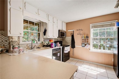 Kitchen featuring a wainscoted wall, light counter