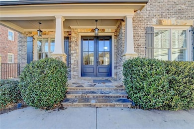 Doorway to property featuring french doors and bri
