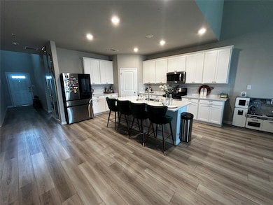Kitchen with stainless steel appliances, light wo