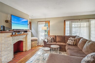 Living room featuring hardwood / wood-style flooring and a brick fireplace
