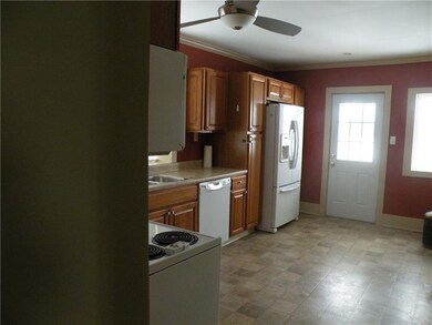 Door from kitchen leads to fenced back yard