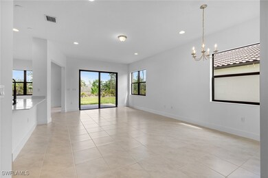 Spare room with a chandelier, light tile patterned