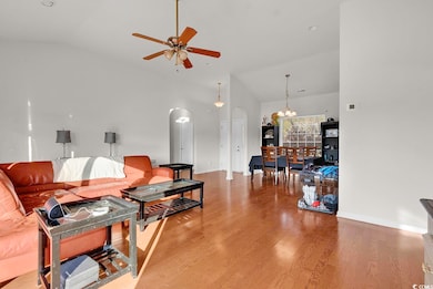 Living area with lofted ceiling, ceiling fan with 