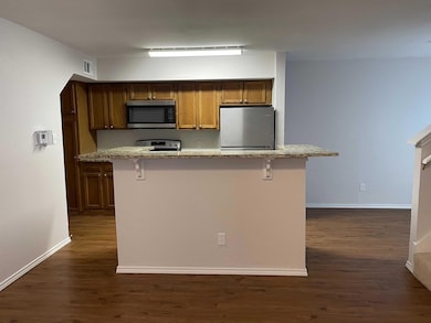 Kitchen with stainless steel appliances, dark wood