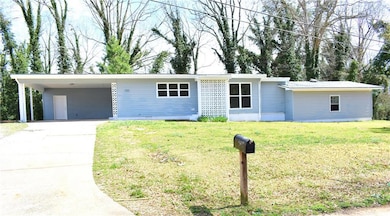 Single story home featuring an attached carport, c