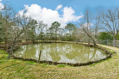 Tucked behind the home, along the rear property line and chain link fence, you'll enjoy relaxing on the tranquil banks of this peaceful pond with a timber bulkhead.  The water level is maintained by an on-site well.