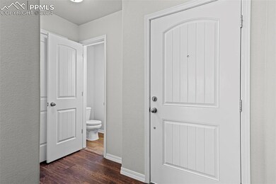 Corridor with dark hardwood / wood-style floors