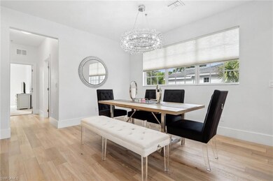 Dining area featuring a chandelier and light hardw