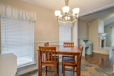 Dining space with a fireplace, dark wood-type floo