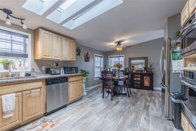 dining area w new ceiling fan and windows, floorin
