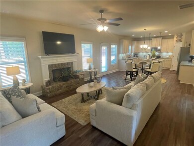 Living room featuring sink, ceiling fan, and dark 