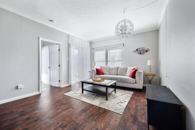 Living room featuring a textured ceiling, crown m