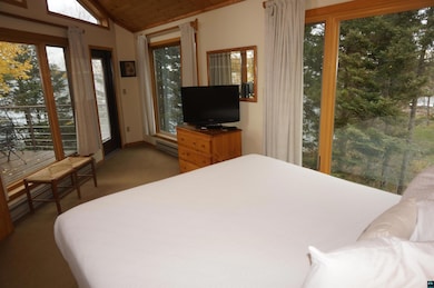 Bedroom featuring wooden ceiling, a baseboard radi