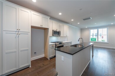 Kitchen with stainless steel appliances and white