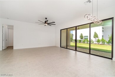 Unfurnished room with ceiling fan, baseboards, and light tile patterned floors