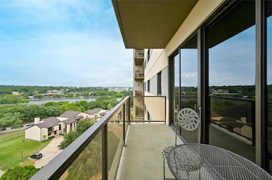One of the two balconies in Residence 8C1 is located in the master bedroom, offering breathtaking views of Lady Bird Lake, lush trees, and the vibrant community below.